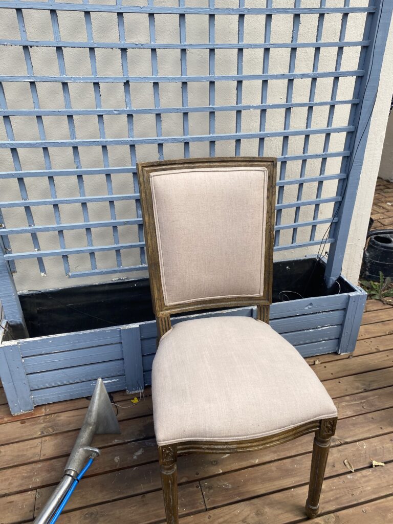 A picture of a chair in the process of being cleaned