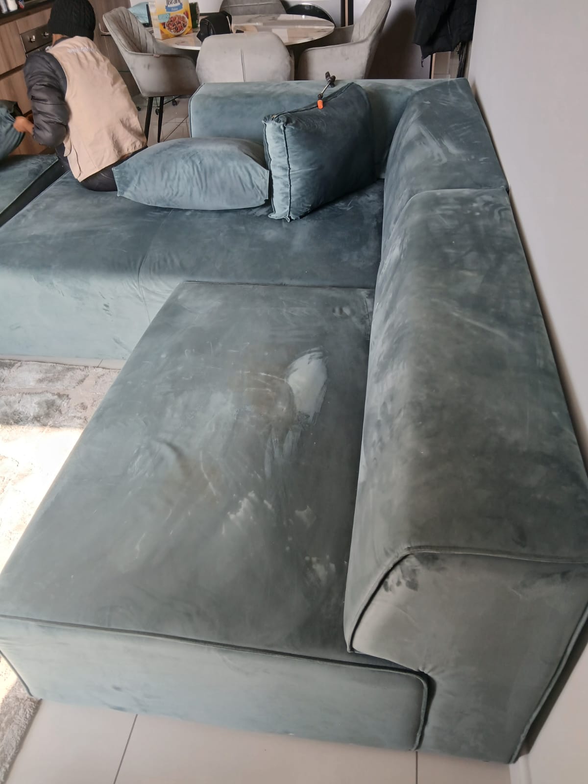 Couch cushions before deep cleaning with visible discoloration and buildup